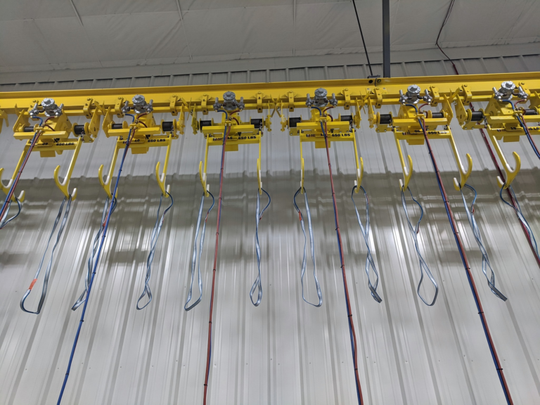 The installation includes 20 custom, wire rope, air-operated hoists with double sister hooks. image