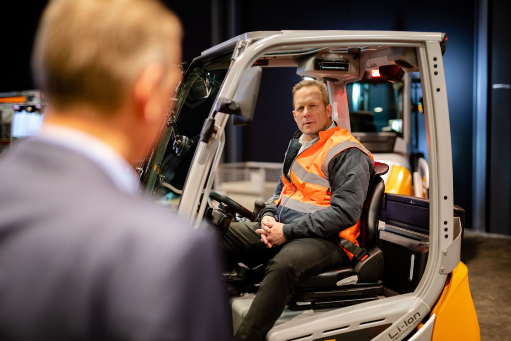 Rob Smith, CEO KION Group AG, sitting in a STILL forklift in Hamburg image