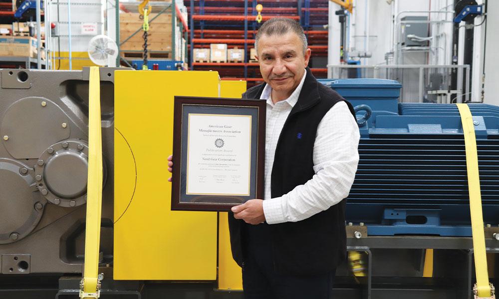 NORD Product Manager for Industrial Drives, Hani Almoghrabi, pictured with the award for his contributions to the published AGMA document on thermal capacity of gear reducers image