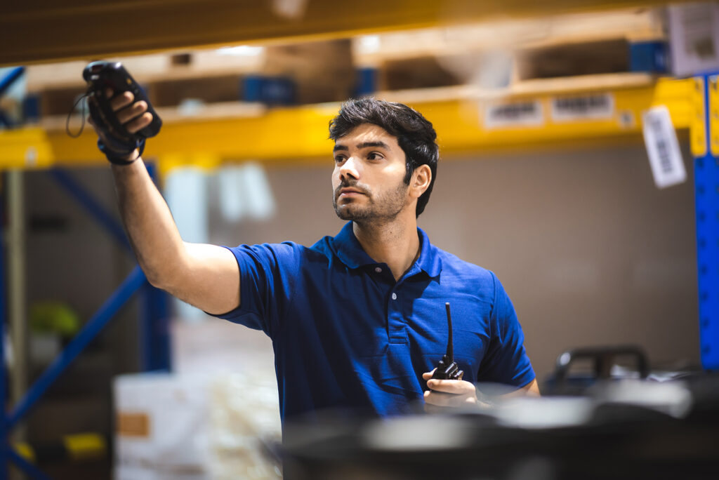 warehouse worker using bar code scanner to analyze newly arrived goods for further placement in storage department, logistic working at warehouse image