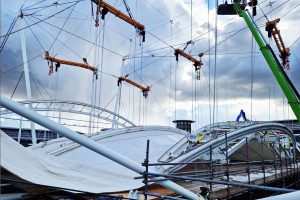 Hoist & Winch specified and supplied a complete hoisting solution that enabled safe, even lowering of the original fabric roof to ground level and raising of the replacement fabric roof to its final installation image