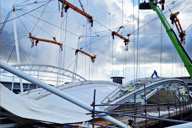 Hoist & Winch specified and supplied a complete hoisting solution that enabled safe, even lowering of the original fabric roof to ground level and raising of the replacement fabric roof to its final installation image