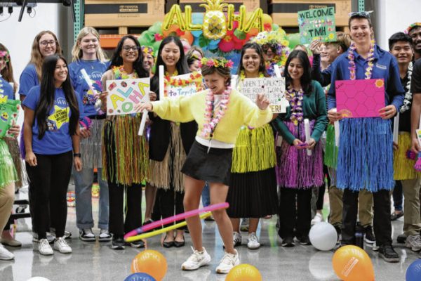 Carla Clark | For The Republic Surrounded by Toyota employees, Harper Booram tries to hula hoop after she is told she and her family are going to Hawaii during the Toyota Make-A-Wish CEO for the Day at Toyota Material Handling, Columbus, Ind., Wednesday, June 11, 2025 image
